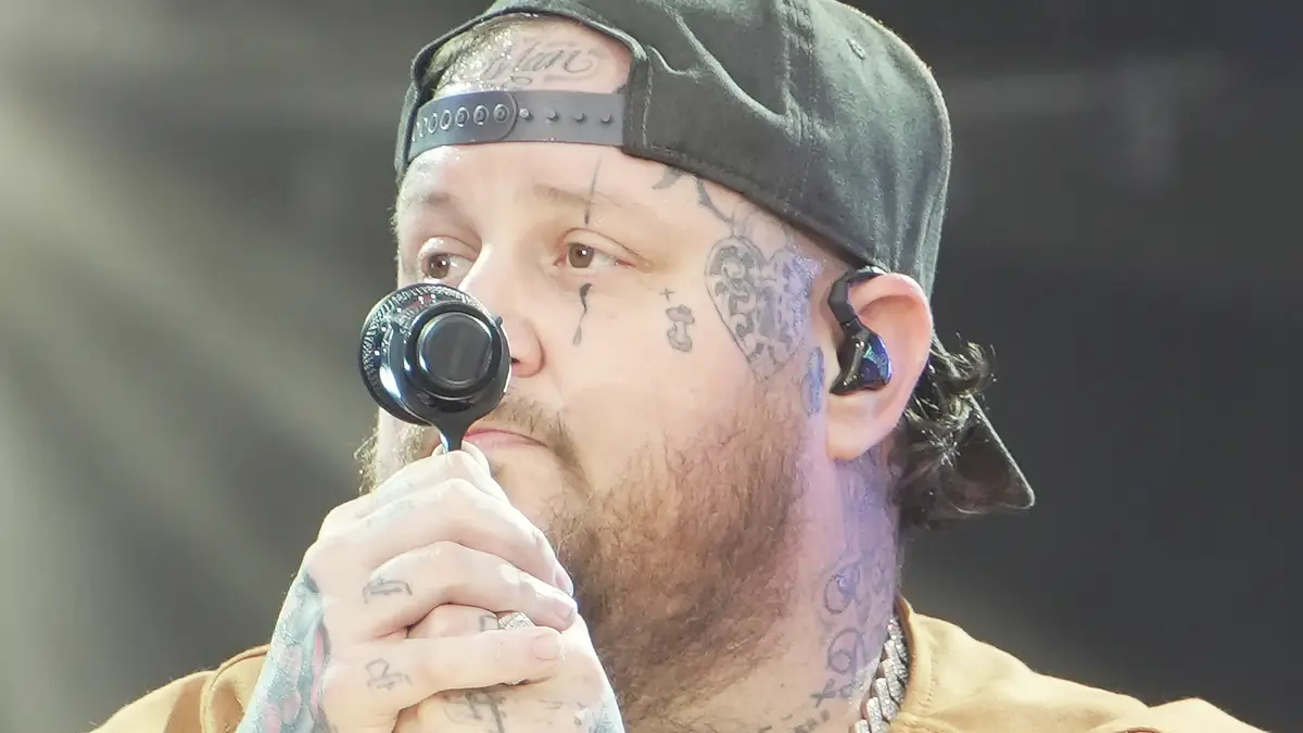 Jellyroll performing live at the Global Citizen Festival on September 28, 2024. The artist is on stage ready to sing, holding both arms with